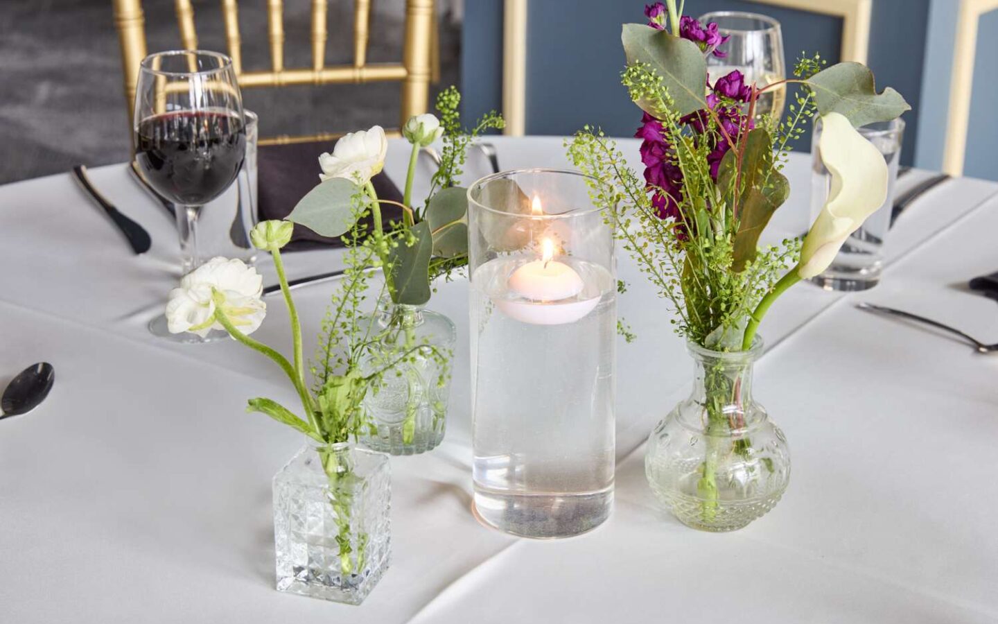 a table with flowers and candles on it