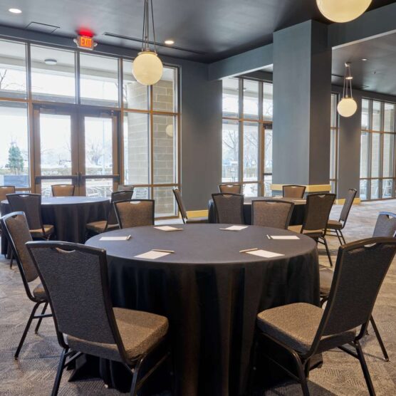 a banquet room with round tables and chairs