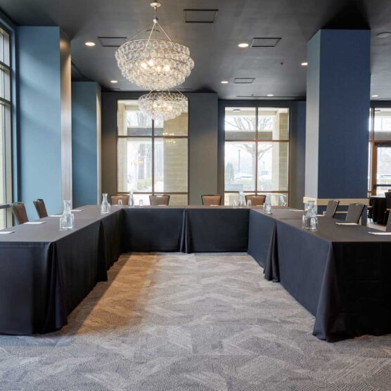 u shaped meeting table surrounded by chairs