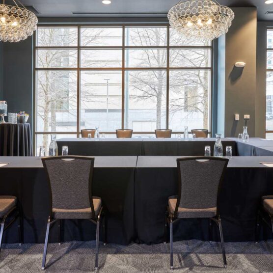 u shaped meeting table surrounded by chairs