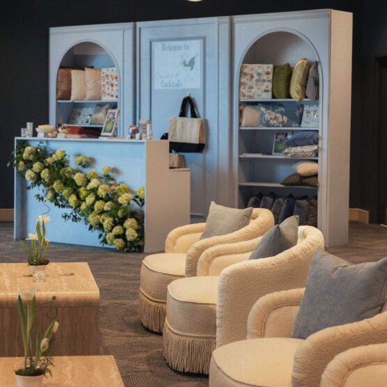 tables and chairs with large display shelf in the background