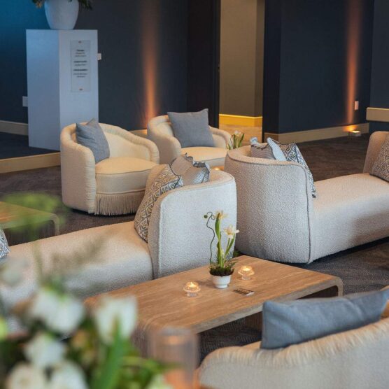 seating area with sofas, chairs, and tables