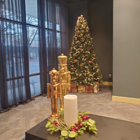 a christmas tree with wrapped boxes under it in a large room