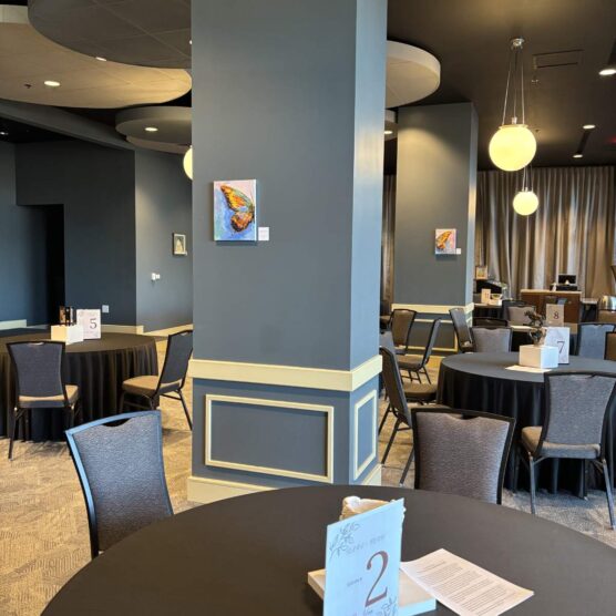 round tables and chairs set up in a large room