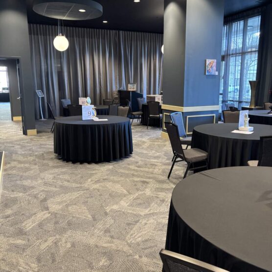 round tables and chairs set up in a large room