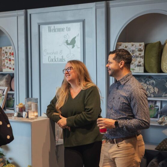 a man and woman having drinks at a counter