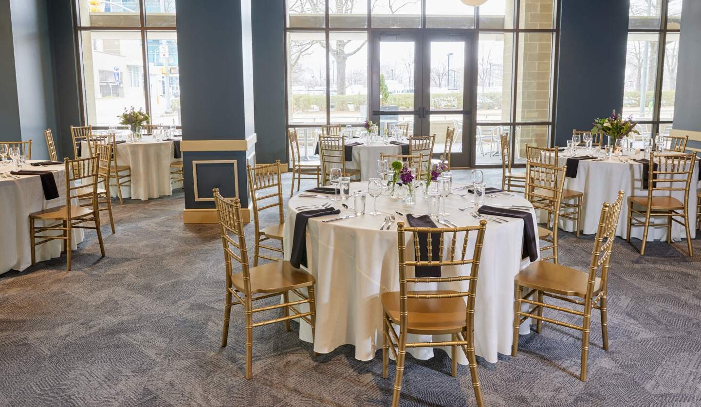chairs and round tables set up for a wedding reception